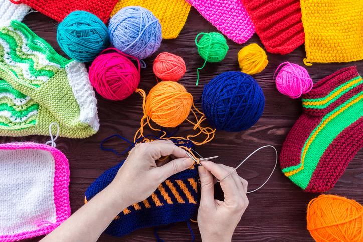 Hands crocheting with warm yarn